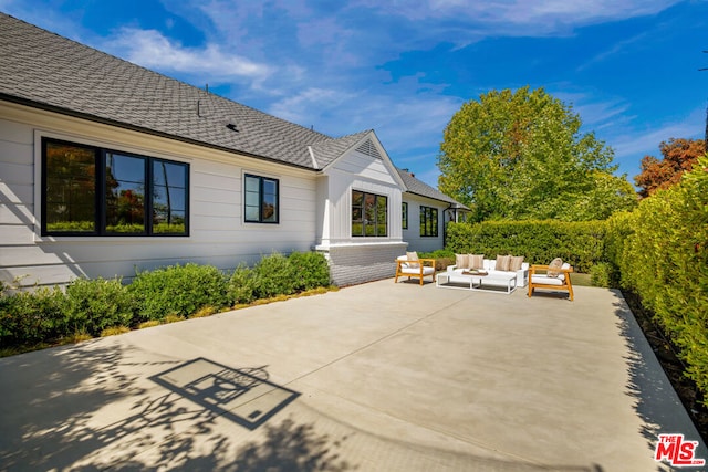 rear view of house with an outdoor hangout area and a patio