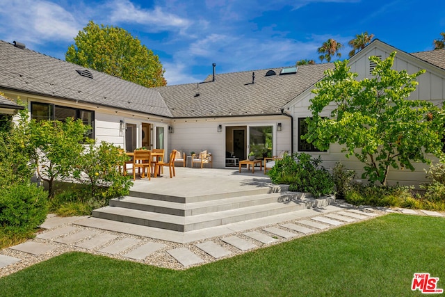 back of house with a patio area, a yard, and french doors