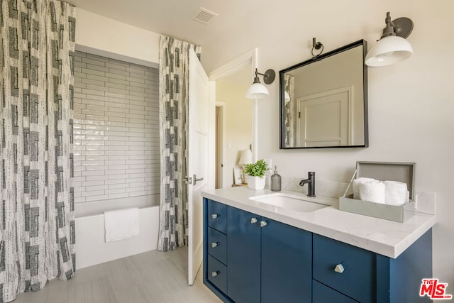 bathroom with vanity and shower / tub combo with curtain