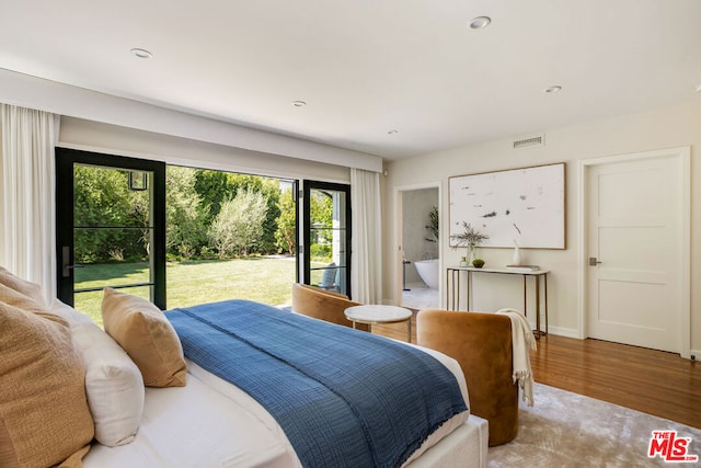 bedroom featuring light wood-type flooring and access to outside