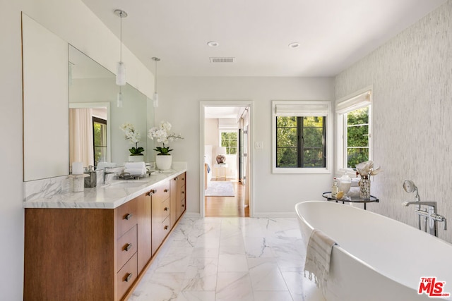 bathroom featuring a bathing tub and vanity