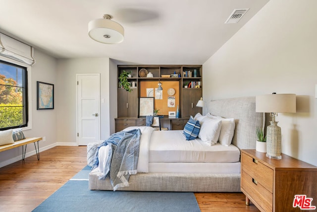 bedroom with hardwood / wood-style flooring