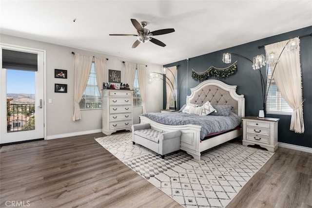 bedroom with wood-type flooring, multiple windows, ceiling fan, and access to exterior