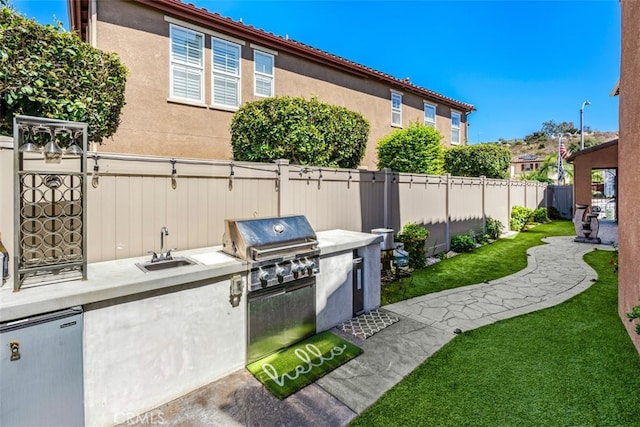 view of patio / terrace featuring area for grilling and sink