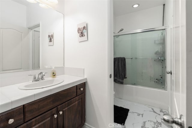 bathroom with shower / bath combination with glass door and vanity