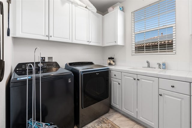 laundry area with cabinets, sink, and washer and dryer