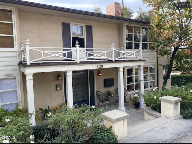 entrance to property with a balcony