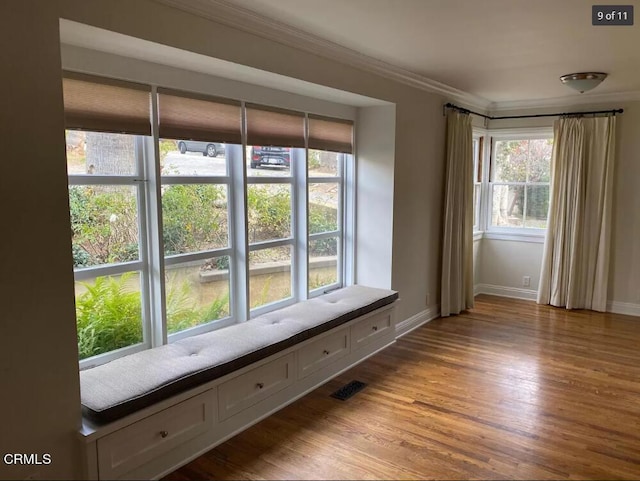 interior space with ornamental molding and light wood-type flooring