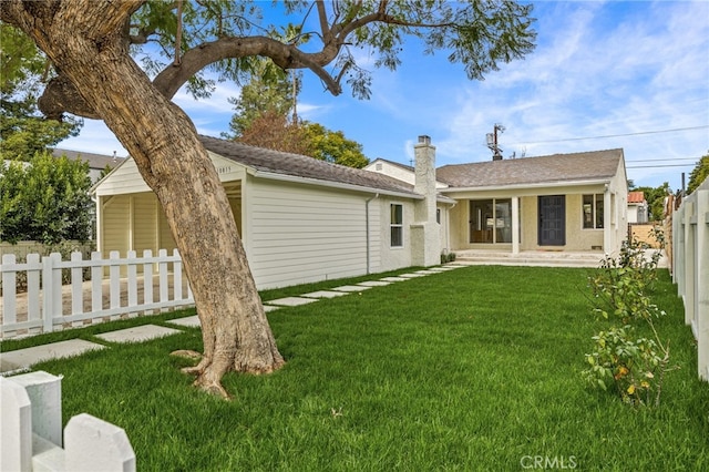 back of property featuring a lawn