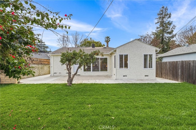 rear view of property featuring a patio, a fenced backyard, and stucco siding