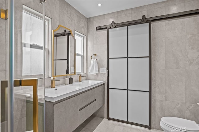 bathroom featuring vanity, tile walls, toilet, and tile patterned floors