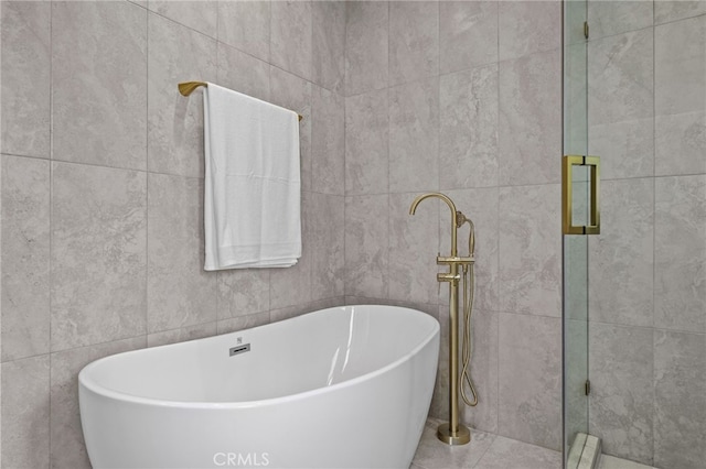 bathroom featuring tile walls and plus walk in shower