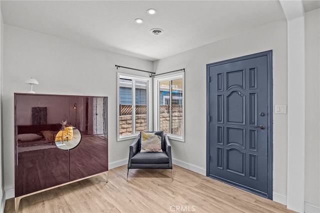 entryway with hardwood / wood-style floors