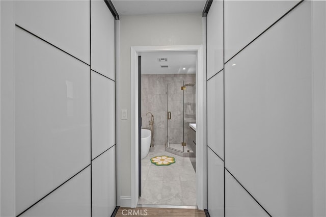 bathroom featuring independent shower and bath and wood-type flooring