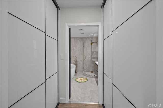 bathroom with a freestanding tub and a shower stall
