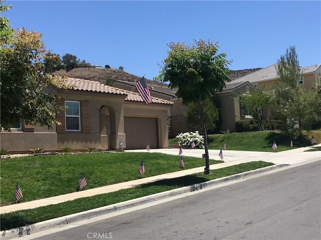 view of front facade with a garage and a front lawn