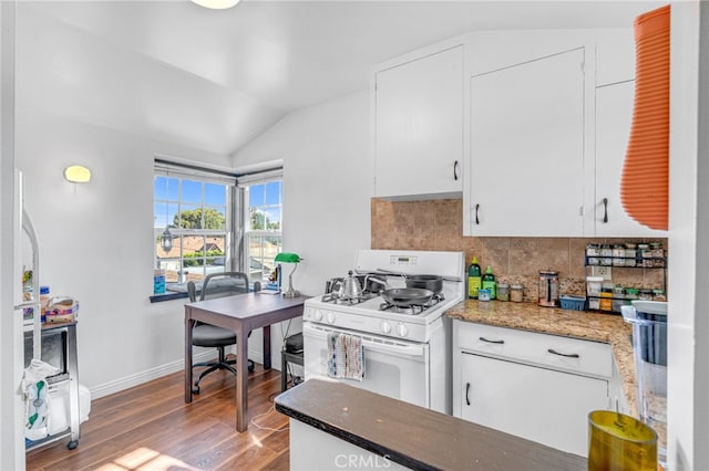 kitchen with white cabinets, lofted ceiling, dark wood-type flooring, white range with gas stovetop, and dark stone counters