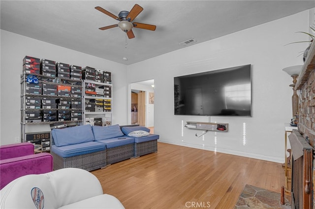 living room featuring a textured ceiling, hardwood / wood-style floors, and ceiling fan