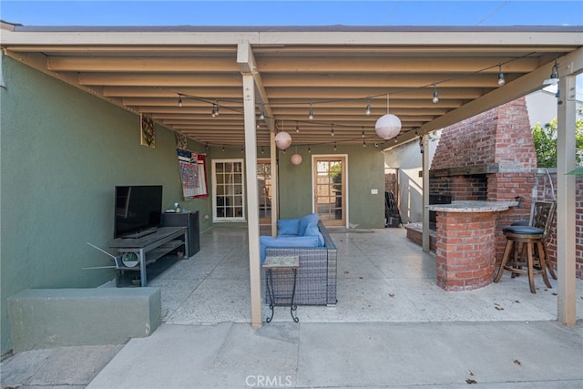 view of patio / terrace with an outdoor bar and an outdoor fireplace