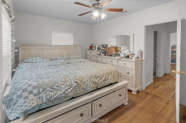 bedroom with light hardwood / wood-style floors and ceiling fan