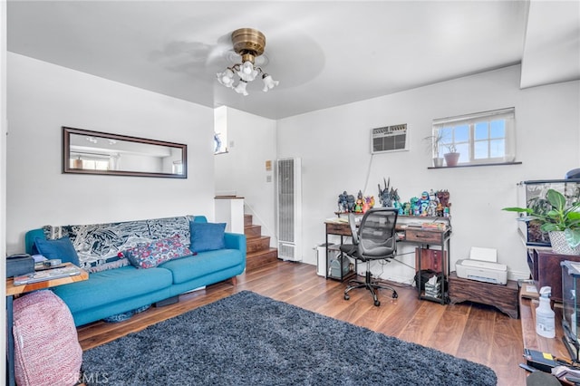 living room featuring ceiling fan, hardwood / wood-style floors, and a wall mounted AC