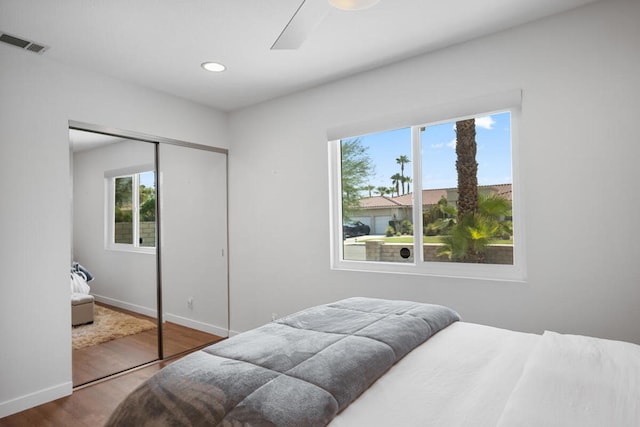 bedroom featuring hardwood / wood-style floors, a closet, and ceiling fan