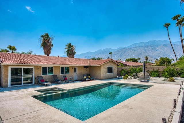 view of pool with a mountain view and a patio area