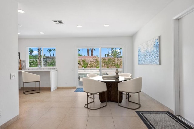 tiled dining area featuring a healthy amount of sunlight