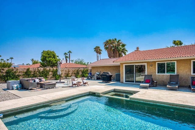 view of swimming pool with an outdoor living space, an in ground hot tub, and a patio area