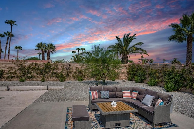 patio terrace at dusk featuring an outdoor hangout area