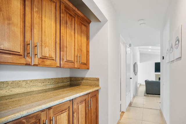 interior space featuring light tile patterned flooring and light stone countertops