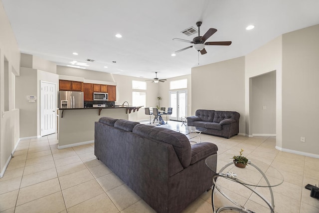 tiled living room featuring ceiling fan