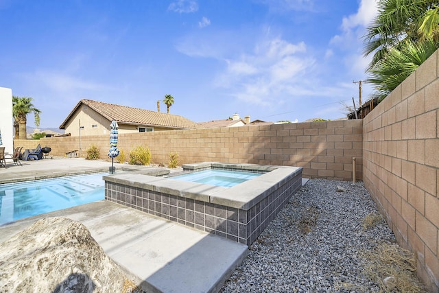 view of pool featuring an in ground hot tub and a patio area