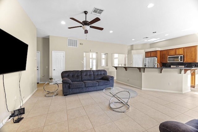 tiled living room featuring ceiling fan