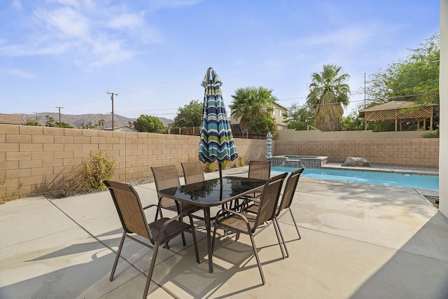 view of patio with an in ground hot tub