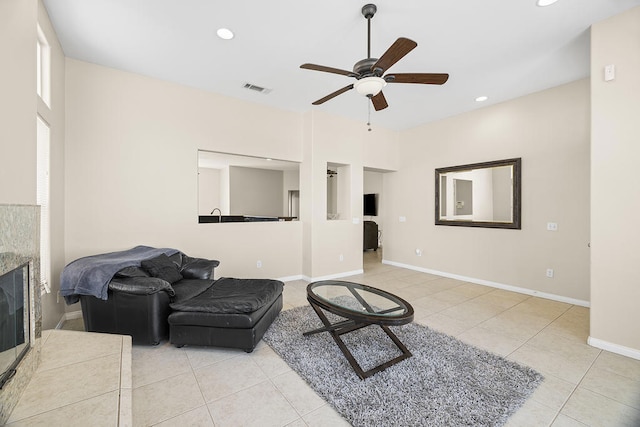 living room featuring ceiling fan and light tile patterned floors