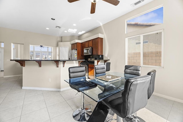 dining area featuring plenty of natural light and light tile patterned floors