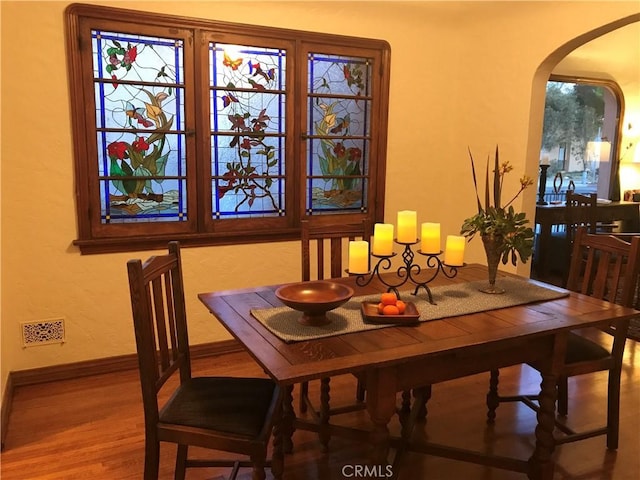 dining space with hardwood / wood-style flooring