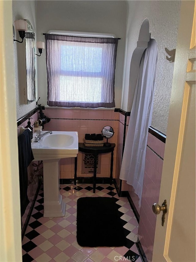 bathroom with tile walls