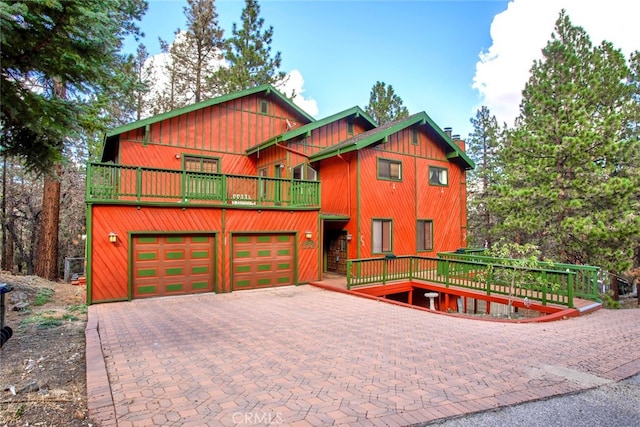 view of front of home with a garage and a balcony