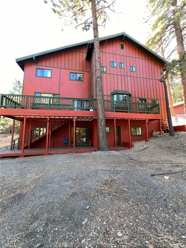 back of property with a wooden deck