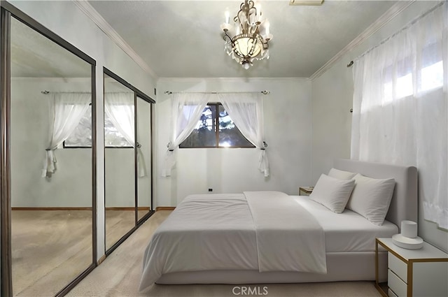 bedroom featuring light carpet, multiple closets, ornamental molding, and a chandelier