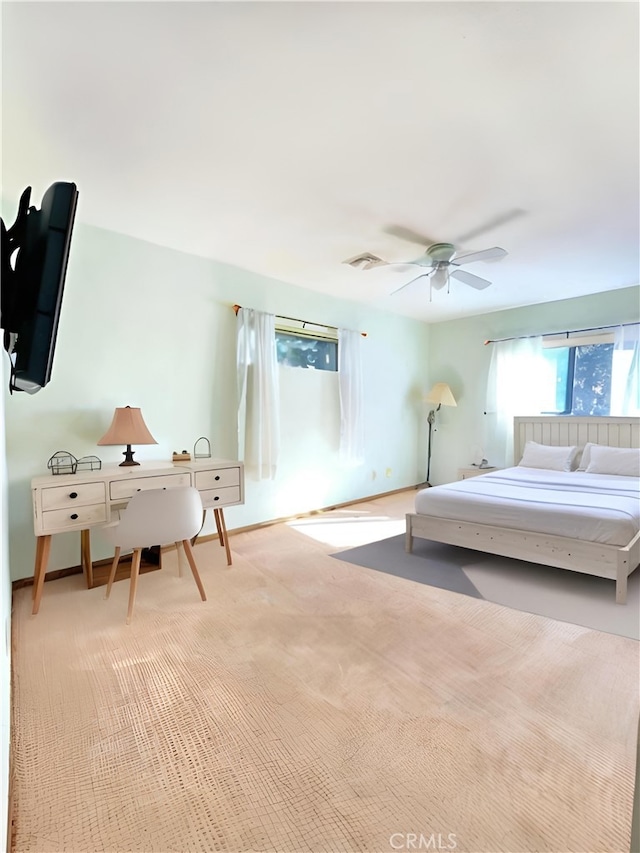 bedroom featuring light colored carpet and ceiling fan