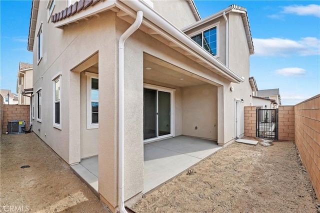 back of property with a patio and central air condition unit