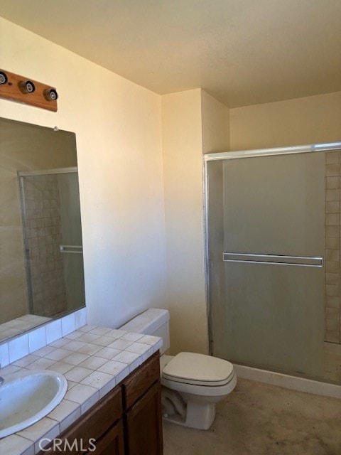 bathroom featuring a shower with door, toilet, and vanity