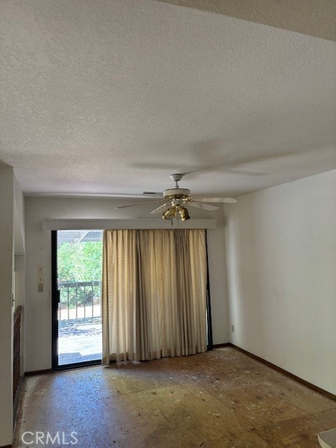 spare room with ceiling fan and a textured ceiling