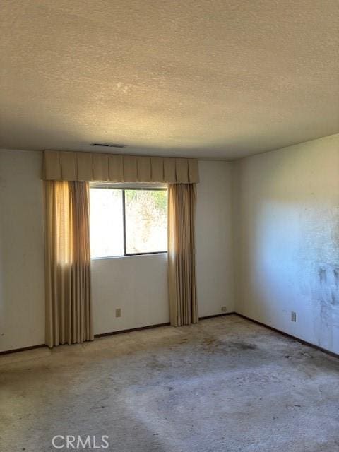 19189 Mountain Mdw N, Hidden Valley Lake, CA 95467 - unfurnished room featuring light colored carpet, a textured ceiling, and baseboards
