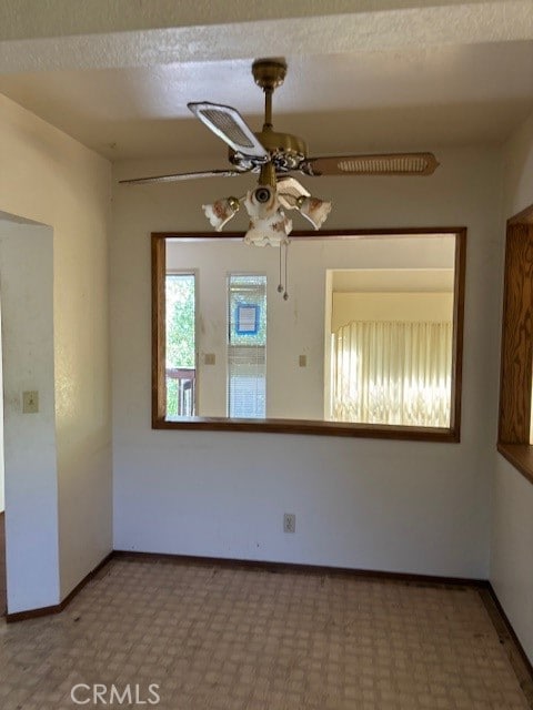 empty room featuring a textured ceiling and ceiling fan