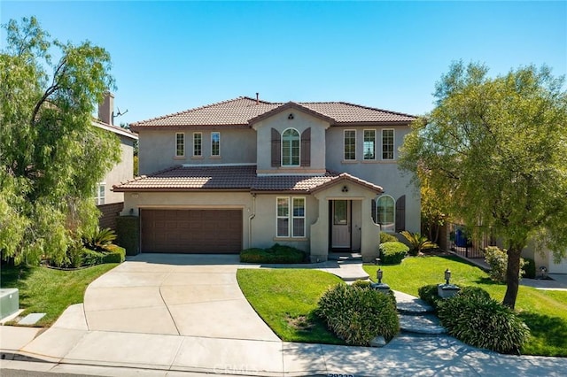 mediterranean / spanish-style house with a front yard and a garage