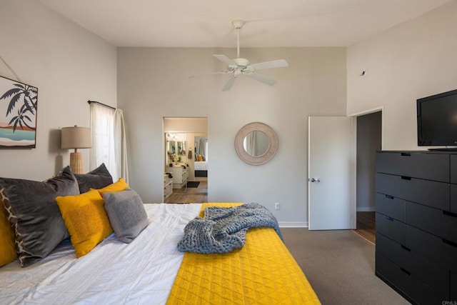 carpeted bedroom featuring ensuite bath, ceiling fan, and a towering ceiling